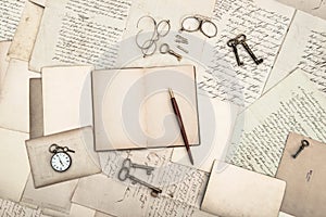 Open book, vintage accessories, old letters