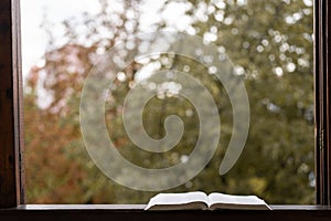 Open book on a vintage windowsill. Read