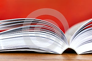 Open book with visible pages against red background