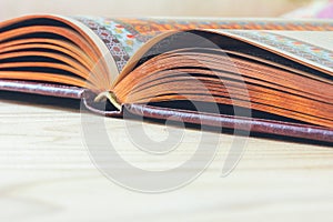 Open book on the wooden table with copy space,