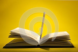 Open book on yellow