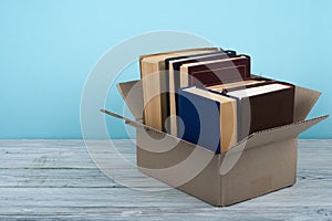 Open books on on wooden deck table and blue background. Back to School. Education concept with copy space for your ad