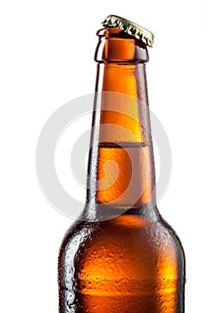 Open bottle of beer with drops isolated on white