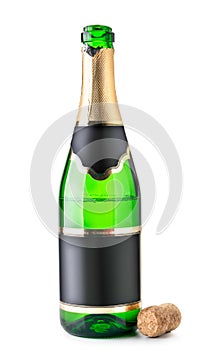 Open bottle of champagne is half empty with a cork on a white. Isolated