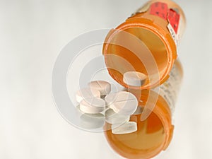 Open bottle of prescription opioids on white with copy space.