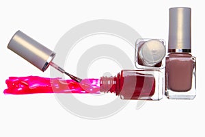 Open bottle with red nail polish. Stripe of nail polish. Brush. Closed vials. White background.