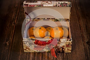 Open box full of ripe juicy tangerines, Christmas fruits