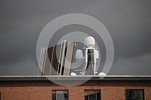 Open bridge and radar installation above a building in Waddinxveen during transport of new yacht Lonian in the Netherlands.