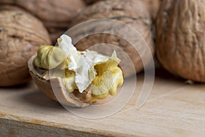 Open and broken walnut shells lying on the table