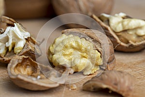 Open and broken walnut shells lying on the table
