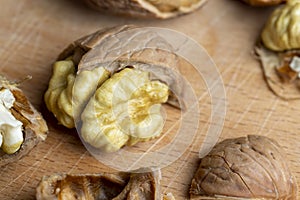 Open and broken walnut shells lying on the table