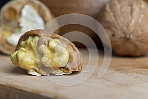 Open and broken walnut shells lying on the table