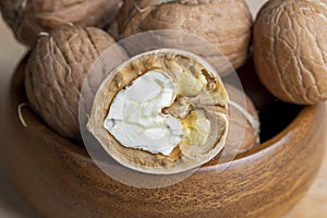Open and broken walnut shells lying on the table