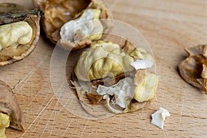 Open and broken walnut shells lying on the table