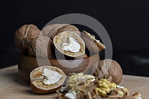 Open and broken walnut shells lying on the table