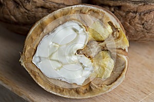 Open and broken walnut shells lying on the table