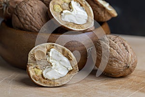 Open and broken walnut shells lying on the table