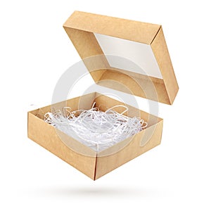 Open brown cardboard gift box with shredded paper isolated
