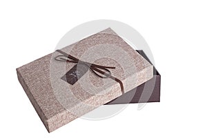 Open brown gift box with leather ribbon and the words `For you` on a white background.