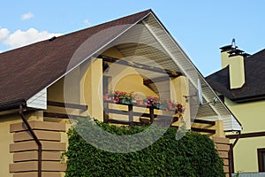 Open brown wooden balcony with flowerpots