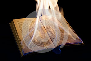 Open burning book with black background