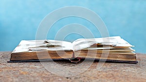 An open burnt book on a rusty metal surface photo