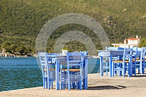 Open cafe outdoor restaurant in Greece on sea shore