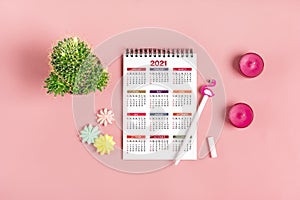 Open Calendar 2021 on tablet, glasses, cup of coffee, pen, smartphone, succulents on marble table