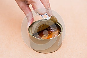 Open canned fish by ring pull