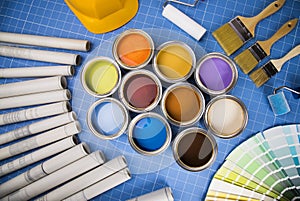 Open cans of paint,Brush, blue background