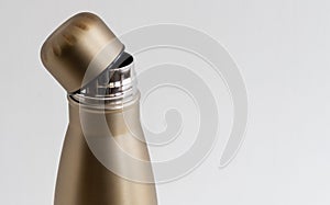 Open cap of metal thermos on white background