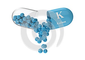 Open capsule with kalium from which the vitamin composition is pouring