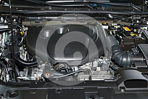 An open car engine in a workshop or garage during maintenance