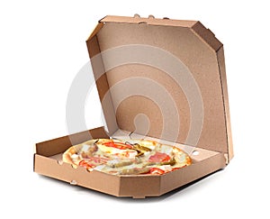 Open cardboard box with delicious pizza on white background.