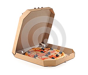 Open cardboard box with delicious pizza on white background.