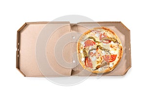 Open cardboard box with delicious pizza on white, top view. Food delivery