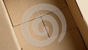 Open cardboard box. Empty paper parcel container close up.