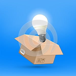 Open cardboard box with a glowing idea light bulb
