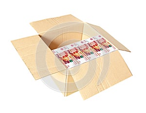 Open cardboard box half filled with bundles of Russian five thousand ruble bills