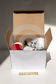 Open cardboard box with medicines.