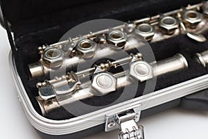 Open case with a flute lying in it with large keys close-up