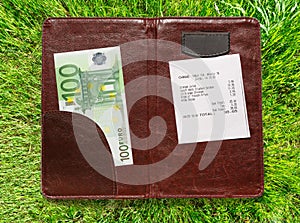 Open check folder with bill and euro