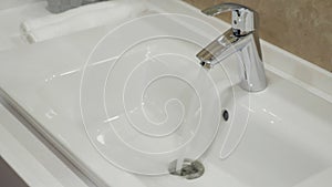 Open chrome faucet washbasin in bathroom