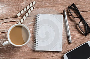 Open a clean Notepad, pen, glasses, phone, cup of coffee and biscuits. The office coffee break.