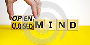 Open or closed mind symbol. Businessman turns cubes and changes concept words closrd mind to open mind. Beautiful yellow table,