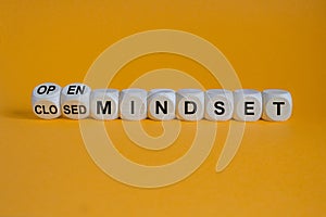 Open or closed mindset symbol. Turned wooden cubes and changes concept words closed mindset to open mindset. Beautiful orange