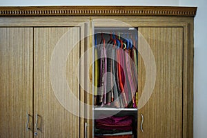 Open closets cupboard wardrobe. Closet with opening doors, clothing and shoes, hats and boxes. Wooden wardrobe with closed doors,