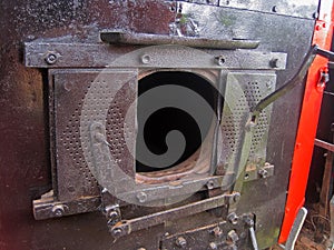 OPEN COAL HATCH ON AN OLD LOCOMOTIVE