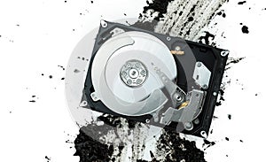 Open computer hard disk drive on muddy background