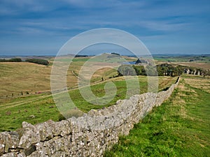 In open countryside, the route of Hadrian`s Wall in Northumberland, England, UK